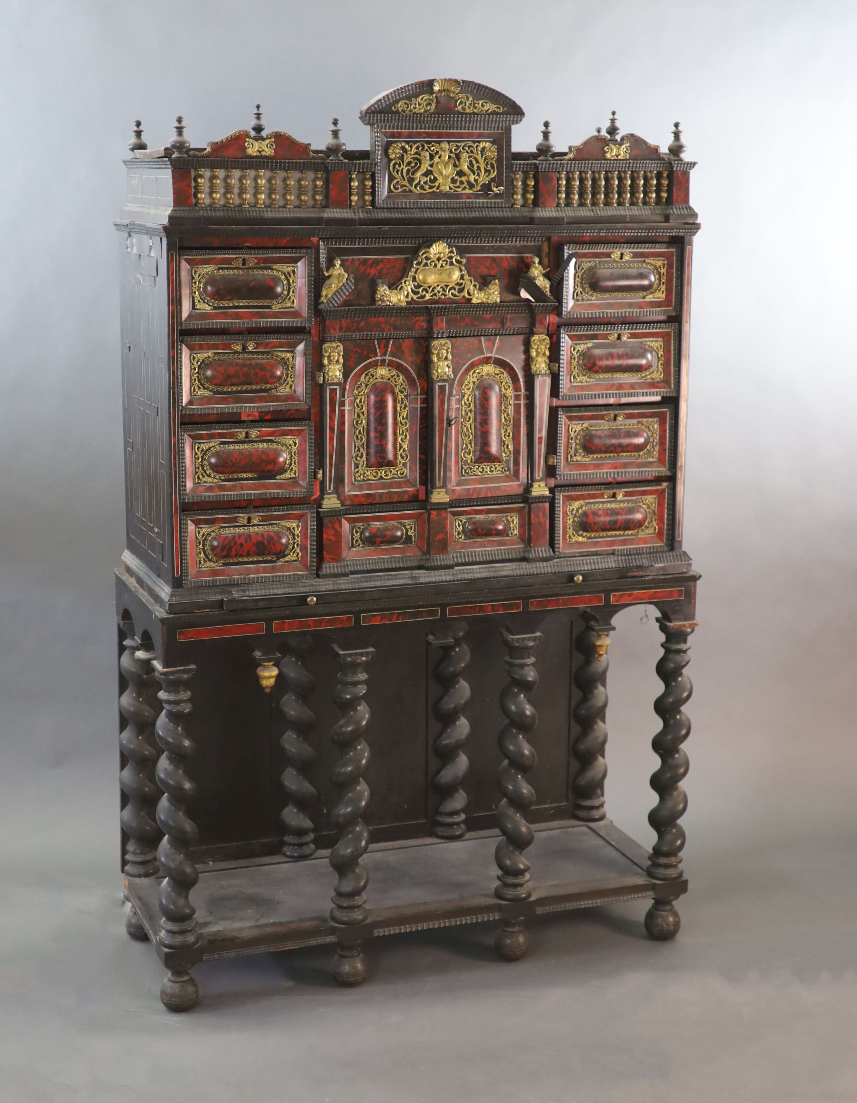 A late 17th century Portuguese ormolu mounted ebony and red tortoiseshell cabinet on stand, W.124cm D.46cm H.187cm